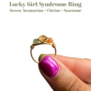 May include: Gold wire wrapped ring with three stones: green aventurine, citrine, and sunstone.  Lucky Girl Syndrome Ring.