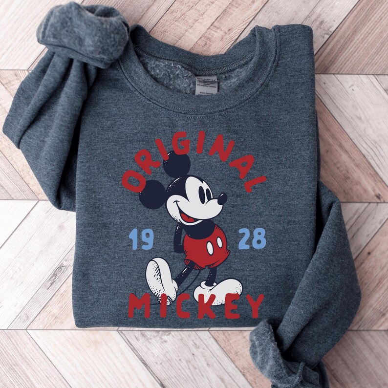 A gray sweatshirt with a graphic of Mickey Mouse printed on it.