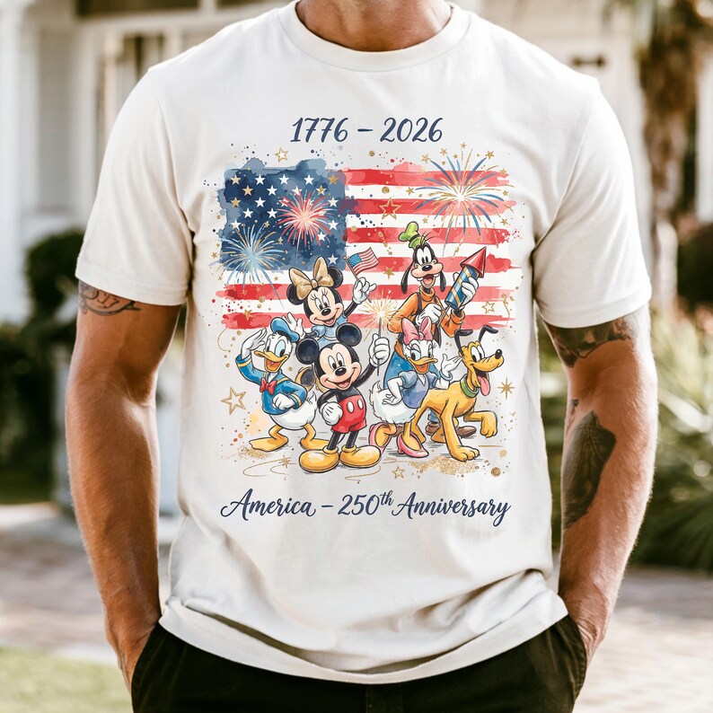 A white t-shirt with a graphic design featuring Disney characters and fireworks, celebrating the 50th anniversary of the United States.
