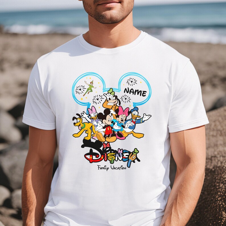 A man wearing a white t-shirt with a Disney character design printed on it.