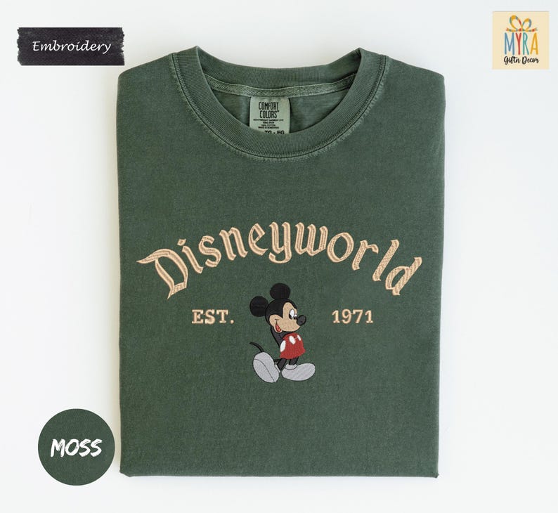 a green t-shirt with a Mickey Mouse design and text that reads "Disneyworld EST. 1971".