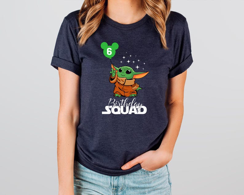A woman wearing a dark blue t-shirt with a graphic of a cartoon character and text that says "Birthday Squad" printed on it.