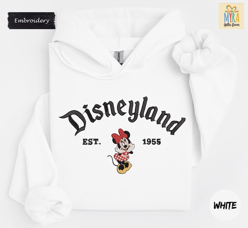 A white hoodie with the text "Disneyland EST. 1955" and a Minnie Mouse graphic printed on it.