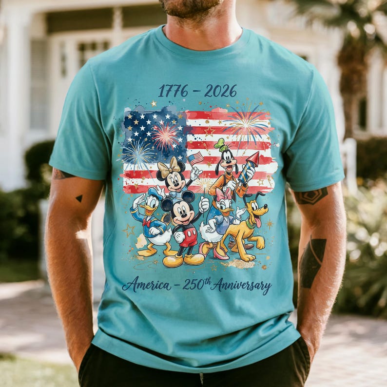 A man wearing a t-shirt with a graphic design featuring Disney characters and fireworks, celebrating the 50th anniversary of the United States.