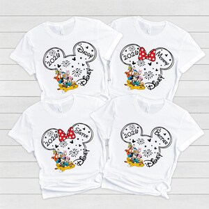 four white t-shirts with Disney-themed designs, including Mickey Mouse and Minnie Mouse characters.