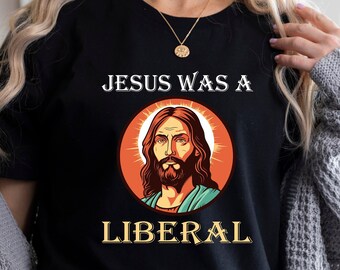 Può includere: Maglietta nera con una grafica di Gesù e il testo "JESUS WAS A LIBERAL".
