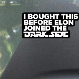 May include: A black and white sticker with the text "I bought this before Elon joined the dark side".