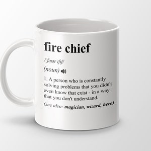 May include: White ceramic mug with a black and white definition of "fire chief" printed on it. The definition reads: "/'faiǝr tfif/ (noun) 1. A person who is constantly solving problems that you didn't even know that exist - in a way that you don't understand. (see also: magician, wizard, hero)"
