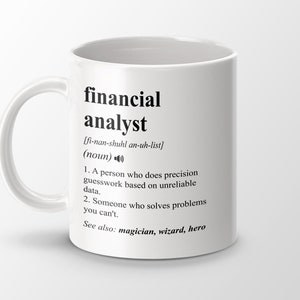 May include: White ceramic mug with a black graphic that defines the word "financial analyst" with a phonetic pronunciation and a humorous definition. The definition reads: "A person who does precision guesswork based on unreliable data. Someone who solves problems you can't. See also: magician, wizard, hero."