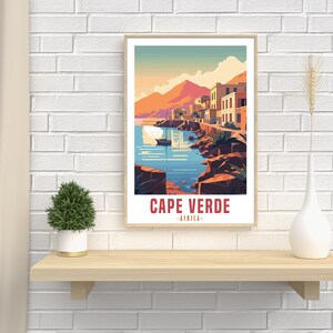 May include: A vintage travel poster with a colorful illustration of a seaside town in Cape Verde, Africa. The poster features a blue ocean, a small boat, and buildings with red roofs.