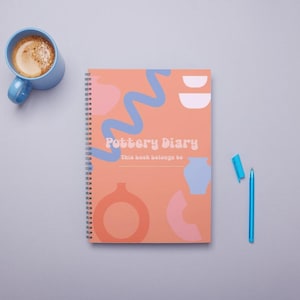 Puede incluir: Una libreta de espiral de color melocotón con un diseño abstracto colorido y el texto "Pottery Diary" y "This book belongs to".