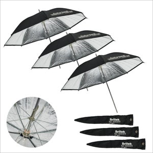 May include: Three silver and black photographic umbrellas with black carrying cases. The umbrellas are open and the silver reflective surface is visible. The carrying cases have the text "Briftek Ref. Umbrella 100 cm" printed on them.