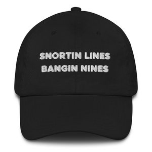 May include: Black baseball cap with white embroidered text that reads "Snortin Lines Bangin Nines".
