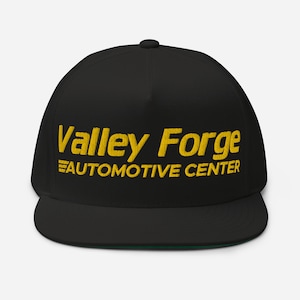 May include: Black and gold embroidered baseball cap with the text "Valley Forge AUTOMOTIVE CENTER".