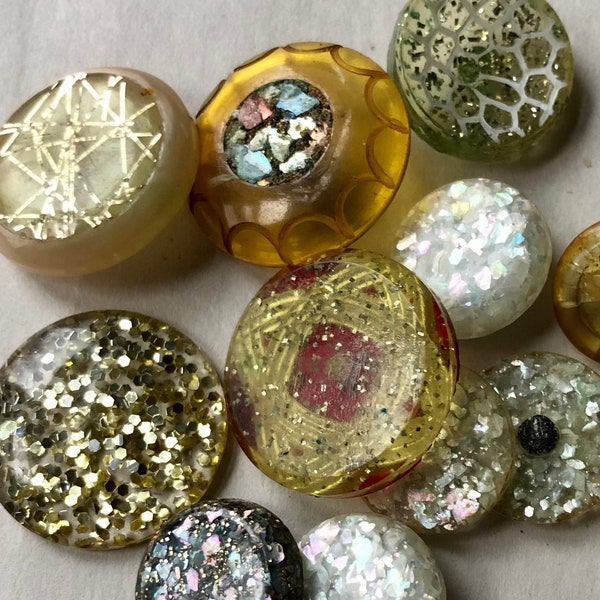 ONE DOZEN BUTTONS. Variety of Plastic/Resin Buttons from the 1950’s - 1960’s. Interesting Sparkle Designs.