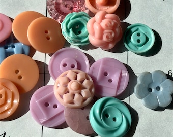 18 PASTEL PLASTIC BUTTONS. Variety of Plastic Buttons from the 1940’s - 1960’s. Great Lot of Spring Colors in a variety of Shapes and Sizes.