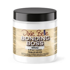 May include: A white jar of Dixie Belle Bonding Boss Problem Solver in white with a black lid. The jar is labelled with the product name, size, and instructions for use. The jar is on a white background.