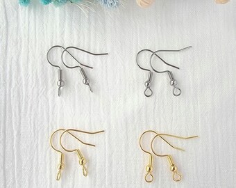 May include: Two pairs of earring hooks, one pair with a perpendicular loop and one pair with a vertical loop. The hooks are silver and gold.