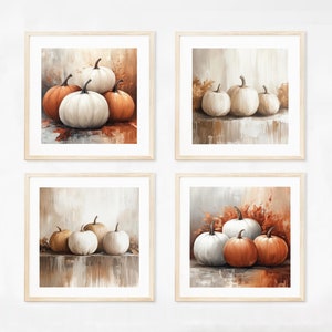 May include: Four framed prints of white and orange pumpkins on a beige background. The pumpkins are arranged in different groupings and are painted in a realistic style.