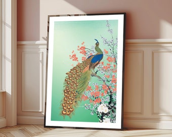 May include: A framed print of a green and blue peacock with its tail feathers spread out. The peacock is perched on a branch of a tree with pink and white blossoms. The background is a light green.