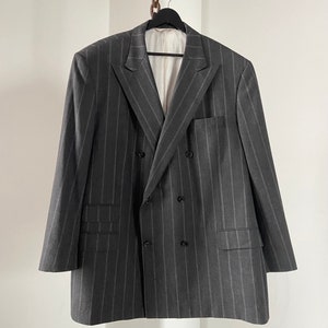 May include: A gray double-breasted blazer with thin vertical stripes.
