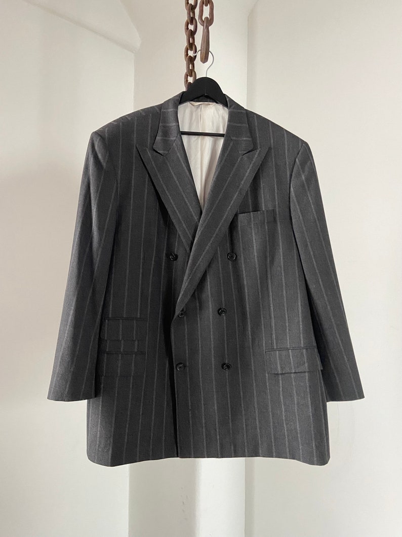 May include: A gray double-breasted blazer with thin vertical stripes.