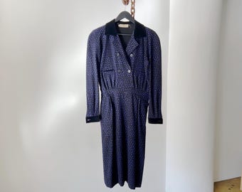 May include: A long-sleeved dress with a black velvet collar and a navy blue and white floral print.