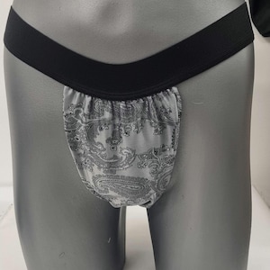 May include: A gray and black patterned underwear with a black elastic waistband.