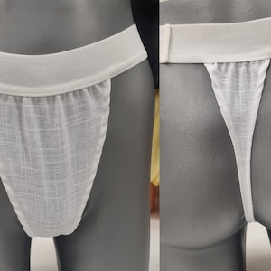 May include: White underwear with a wide elastic waistband and a mesh fabric panel. The underwear is displayed on a mannequin.