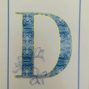 Letra D monograma azul de Delft: acabado a mano con pintura y barniz metálico dorado y plateado.
