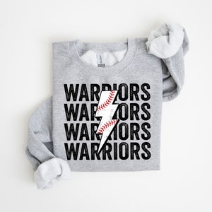 May include: Grey sweatshirt with the words "WARRIORS" repeated four times in black text. A black lightning bolt graphic with a white baseball inside is centred on the sweatshirt.