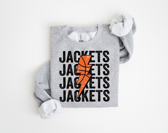 Op de afbeelding: Grijs sweatshirt met een zwarte en oranje basketbal bliksem graphic en de tekst "JACKETS" vier keer herhaald.