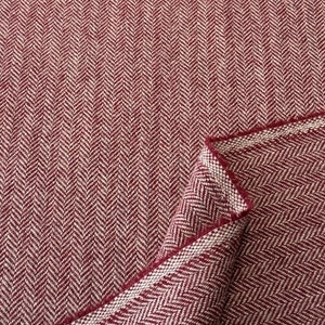 May include: A bolt of fabric featuring a deep red and white herringbone pattern. The textile displays a consistent V-shaped weave throughout the surface, with a folded corner revealing the underside of the material and its woven texture.