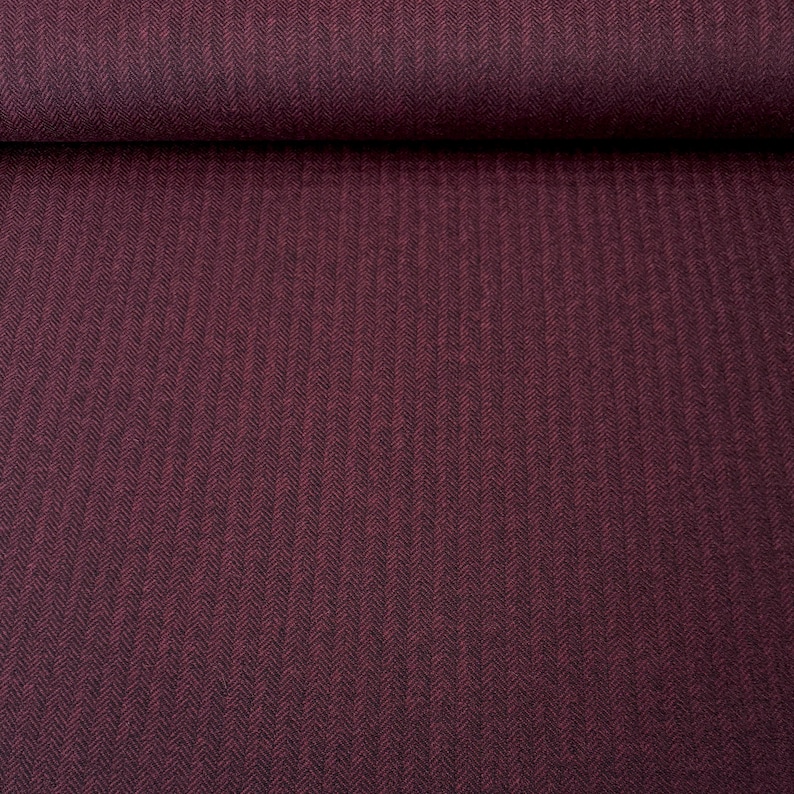 Gesamtansicht eines hochwertigen Fischgrät-Tweeds in Weinrot und Schwarz, in voller Breite. Dieser toller Wollstoff aus Schurwolle ist beidseitig verwendbar und eignet sich perfekt für Blazer, Jacken, Mäntel, Capes, Ponchos, Kostüme, Westen.
