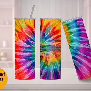 May include: Three stainless steel tumblers with a colorful tie-dye pattern. The tumblers are standing on a white surface.
