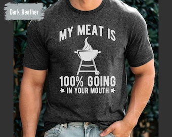 May include: Dark heather grey t-shirt with a white graphic of a grill and the text "My Meat Is 100% Going In Your Mouth".