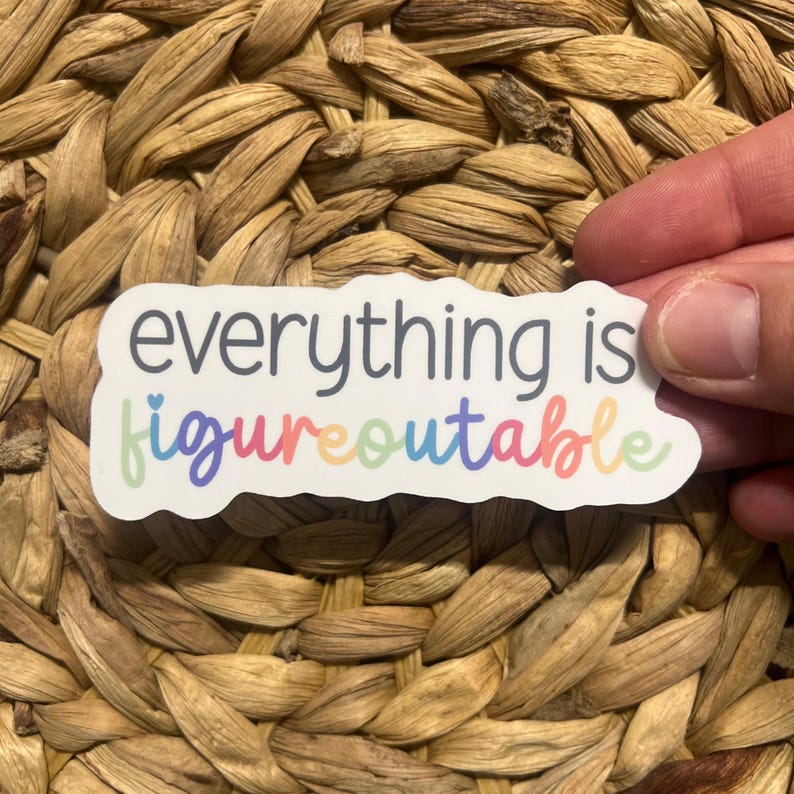 May include: White sticker with the text "everything is figureoutable" in rainbow colors. The sticker has a heart shape in the word "figureoutable".