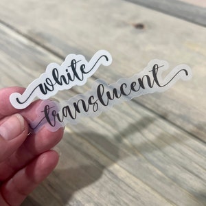 May include: Two clear stickers with black cursive text. The top sticker says "white" and the bottom sticker says "translucent".