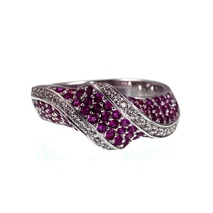May include: A silver ring with a wave design, encrusted with small, vibrant red gemstones and accented with a row of smaller, clear stones. The ring has a modern, elegant style, perfect for special occasions.