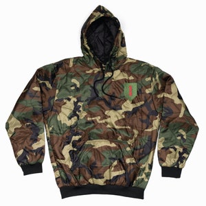 May include: A camouflage hooded sweatshirt with a black lining and a green patch with a red "1" on the left chest.