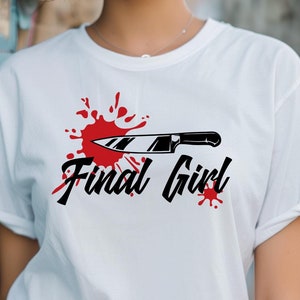 May include: White t-shirt with a black and white graphic of a knife with red blood splatters and the text "Final Girl".