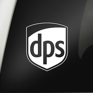 May include: White sticker with a black shield shape and the text "dps" inside. The sticker is on a black car window. The text "LF1M" is visible in the upper right corner of the image.