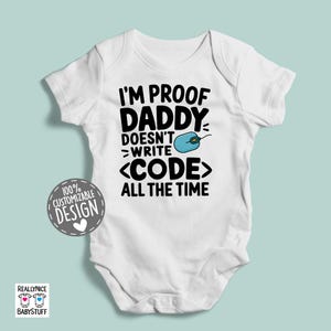 May include: White baby onesie with black text that reads "I'm proof Daddy doesn't >write <CODE> all the time". A blue computer mouse icon is above the word "write".