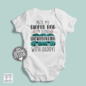 May include: White baby onesie with a green and blue snowboard graphic and the text "Pack my diaper bag I'm going snowboarding with daddy!"