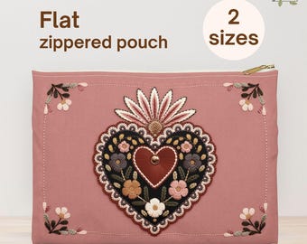 May include: A flat, zippered pouch in a dusty rose color. The pouch features a printed design of a heart with floral and leaf accents. The heart design is in the center, with additional floral accents in the corners. The text "Flat zippered pouch" and "Printed design" are visible.