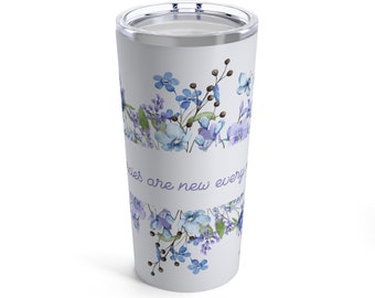 May include: A white travel tumbler with a floral design in shades of blue and purple. The design includes various flowers and foliage, with the words "Memories are new every" in a script font. The tumbler has a silver lid.