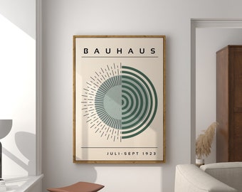 May include: A minimalist poster with the text "BAUHHAUS" in black lettering and a geometric design of a green circle with concentric rings and a sunburst pattern. The text "JULI-SEPT 1923" is below the design.