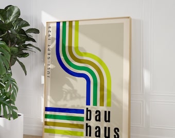 May include: A poster with a Bauhaus design featuring a colourful abstract pattern of blue, green and yellow stripes. The text "JULI-SEPT 1923" is on the left side of the poster, and the text "bauhaus" is on the right side.