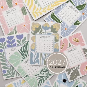 May include: A 2027 calendar featuring multiple pages with floral illustrations in pastel and muted tones. Each page displays a specific month, including January, February, March, April, November, and December, with corresponding dates and days of the week.