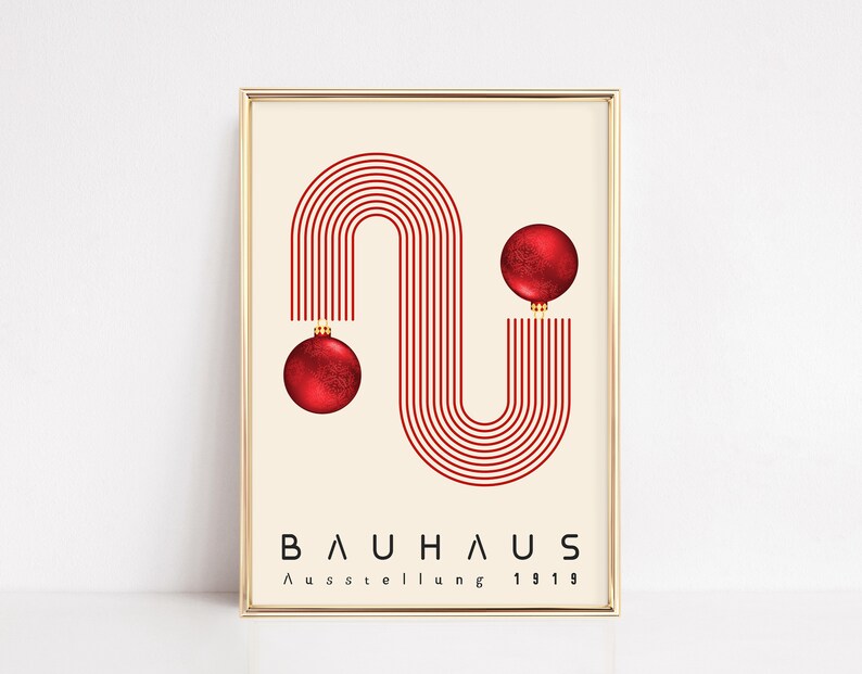 May include: A framed poster featuring a cream background with a red graphic of parallel lines forming an S-shape. Two red spherical ornaments are attached to the ends of the lines. The text BAUHAUS Ausstellung 1919 is printed in black at the bottom.